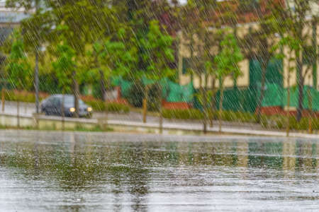 Heavy rain falling and large raindrops crashing to the ground.