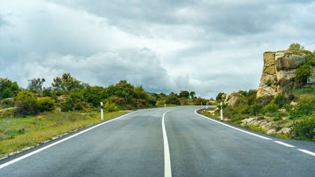 Panorama of mountain road with cloudy storm sky, Guadarrama Madrid.の写真素材