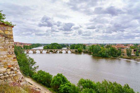 Roman bridge over the river that passes in front of the city of Zamora Spain.の写真素材
