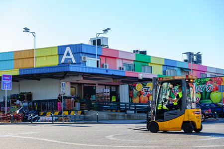 Mercamadrid, Madrid, Spain - June 7, 2022: electric vehicles transporting fruits and vegetables on the market.のeditorial素材