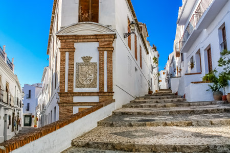 Typical Andalusian white town street with stairs and old houses. Frigiliana Malaga.の写真素材