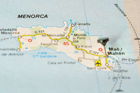 Tourist destination of Menorca marked with a pin on a map, macro photo.の写真素材