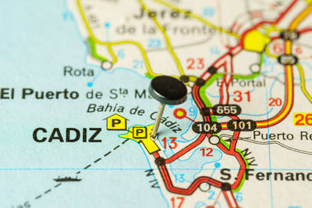 Tourist destination of Cadiz with a pin on a map, macro photo.
