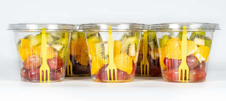 Peeled and cut fruit containers ready to eat in a healthy diet.の写真素材