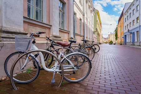 Bicycles parked on the cobbled street in the city of Tartu Estonia.の写真素材