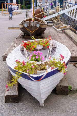 Small decorative boat with flowers and plants inside.の写真素材