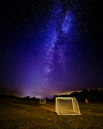 Night image of the Milky Way with starry sky on football field. Sports concept.の写真素材