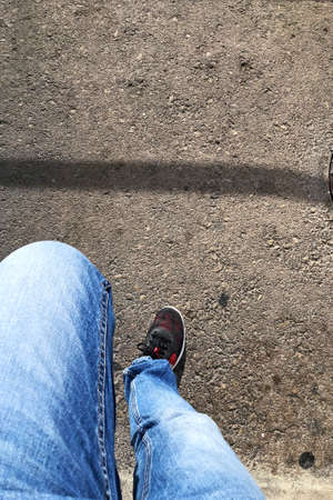 Waiting sitting with jeans and sneakersの写真素材