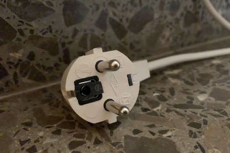 White plug without current isolated in the foreground on the groundの写真素材