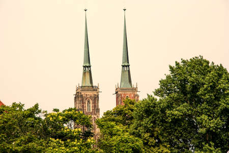 the two towers of the Cathedral of St. John the Baptist, in wroclaw in Poland, hidden brings the treesのeditorial素材