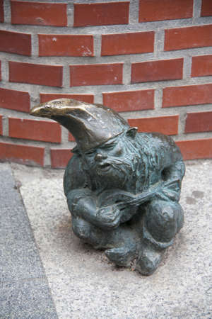 Statue of dwarf, Wroclaw, Poland, man sitting on the street to play guitarのeditorial素材