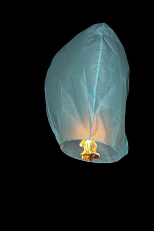 Blue balloon with fire on black backgroundの写真素材