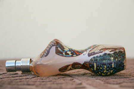 perfume bottle-shaped body of a woman lying on the table chestnut in white background のeditorial素材