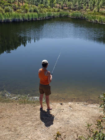 woman fishing in pondの写真素材