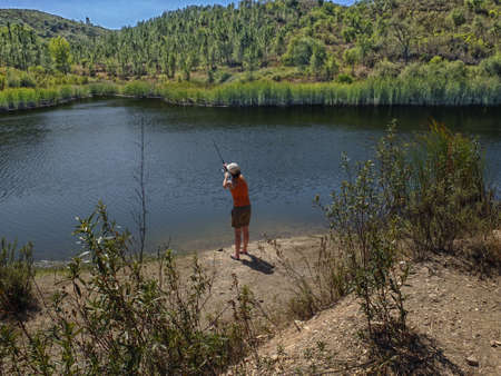 woman fishing in pondの写真素材