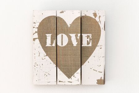 Wall with picture of white wooden boards and painted brown heartの写真素材
