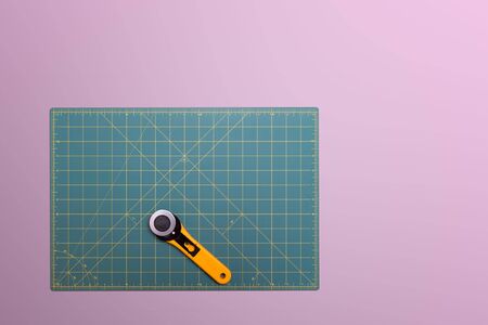 Green cutting base and yellow rotary cutter for DIY, crafts, patchwork and sewingの写真素材