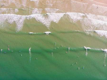 Aerial view of people surfing in the waters of the beaches of San Vicente de la Barquera, Cantabria,...