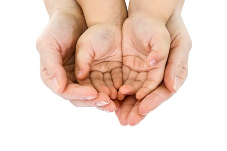 Woman's hand hold a child's handfulの写真素材