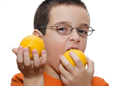 Boy playing with lemons - isolatedの写真素材