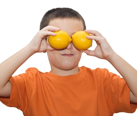 Boy playing with two lemons - isolatedの写真素材