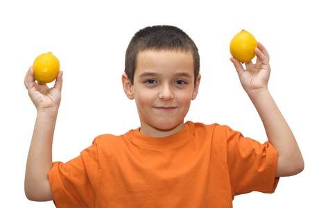 Boy holding in his hand two lemons -isolatedの写真素材
