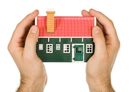 Protective hand holding a modelhouseの写真素材