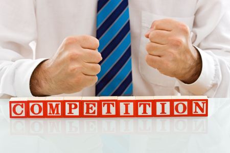 Businessman showing the COMPETITION sign - isolated