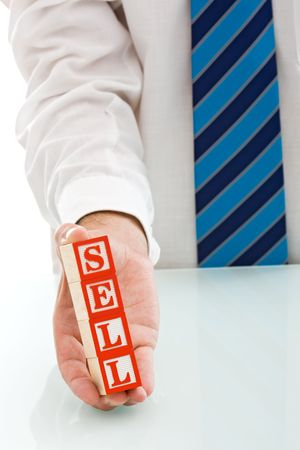 Businessman holding the SELL sign - isolatedの写真素材