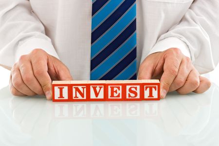 Businessman keep the INVEST sign - isolatedの写真素材