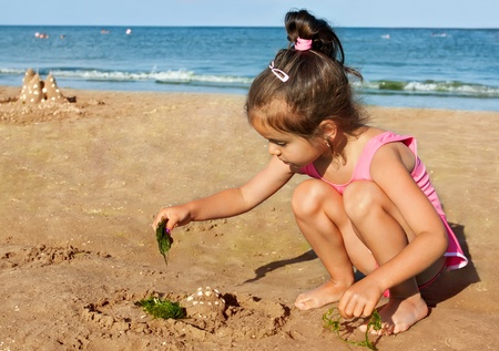 Little girl playing on the seasideの写真素材
