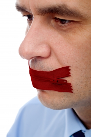 Businessman with red flies on his mouth â concept of keeping secretの写真素材