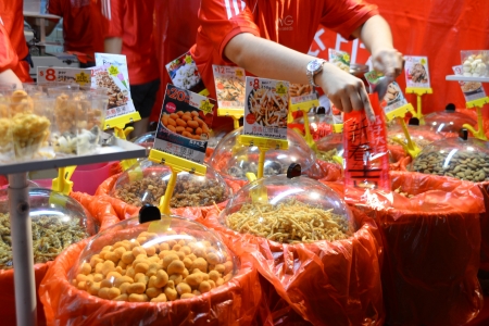 Typical Chinese New Year goodies sold at the Chinatown Night Street Market.  This street is where Chinese New Year goodies are sold and the very centre of CNY celebration in Singapore.  Chinatown, Singapore 18 Jan 2013.のeditorial素材