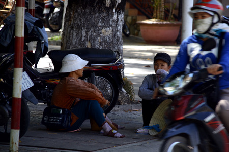 Vietnamese women sitting at street corner chattingのeditorial素材