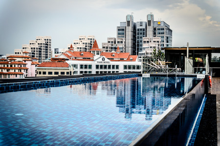 Rooftop infinity pool with deck chair at Clarke Quay Singaporeのeditorial素材
