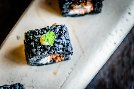 Ikasumi Roll Squid ink rolled rice with cream cheese and deep fried chicken toppingの写真素材