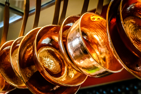 hanging copper pots, pans, saucepansの写真素材