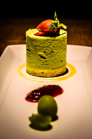 Pistachio panna cotta  italian dessert with raspberry sauce and strawberryの写真素材