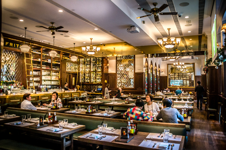 European bistro interior with table settings and chandeliers and stained glass