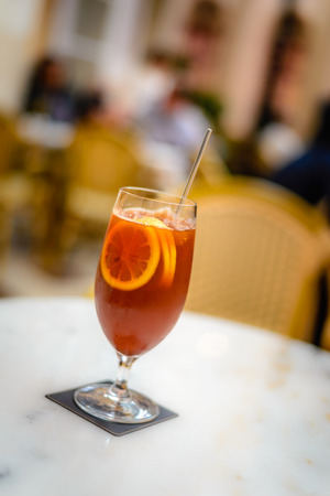 ice lemon tea in a atall glass with three lemon slicesの写真素材