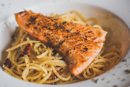 grilled Salmon with Aglio Olio spaghetti with herbの写真素材