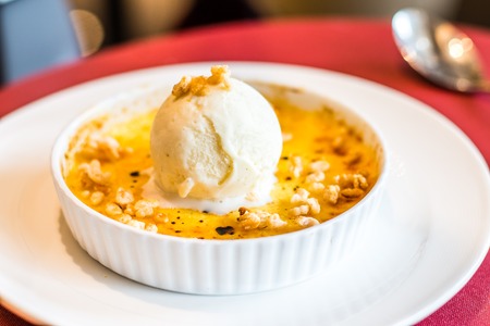 Creme Brulee with vanilla ice cream and crushed nuts