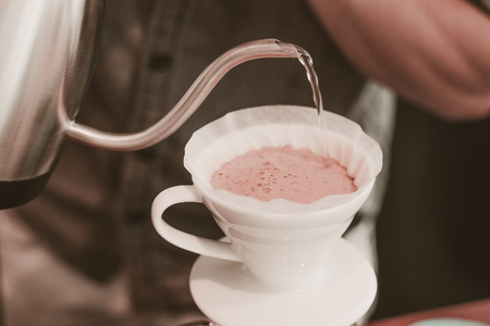 Cafe barista making specialty coffee with coffeee filter  in a cafeの写真素材