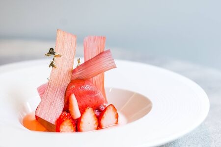 Strawberry & Rhubarb Marinated Gariguette strawberries, rhubarb lightly confit, vanilla chantilly, strawberry and rose sorbetの写真素材