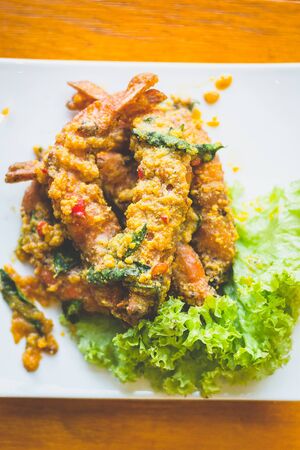 prawns stir fried in salted egg paste and basil and chilliの写真素材