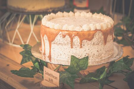 delcicious decorated  display of cakes, cookies, scones and confections in a bakeryの写真素材