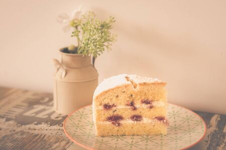 Victorain Sponge cake, a light three layered sponge cake with strawberry jame between layers and lightly dusted with iciing sugar on topの写真素材