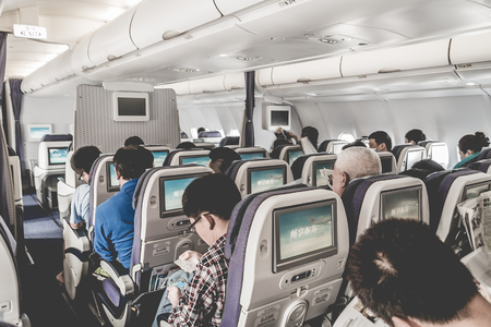 passengers air travellers sitting in airplane cabin during inflight serviceのeditorial素材