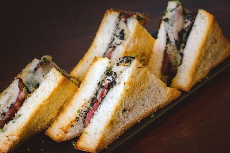 Truffle Tramezzini Melted mozzarella on tender beef bacon in brioche bread with black truffle pate
の写真素材