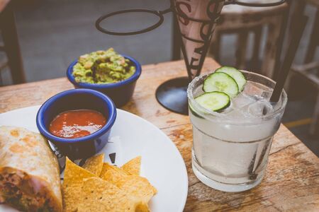la Paloma cocktail and tortilla chips and guacamole  on a tableの写真素材
